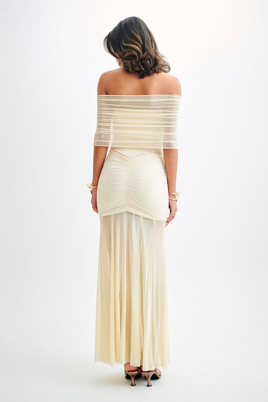 Woman wearing a white off-shoulder dress on a white background