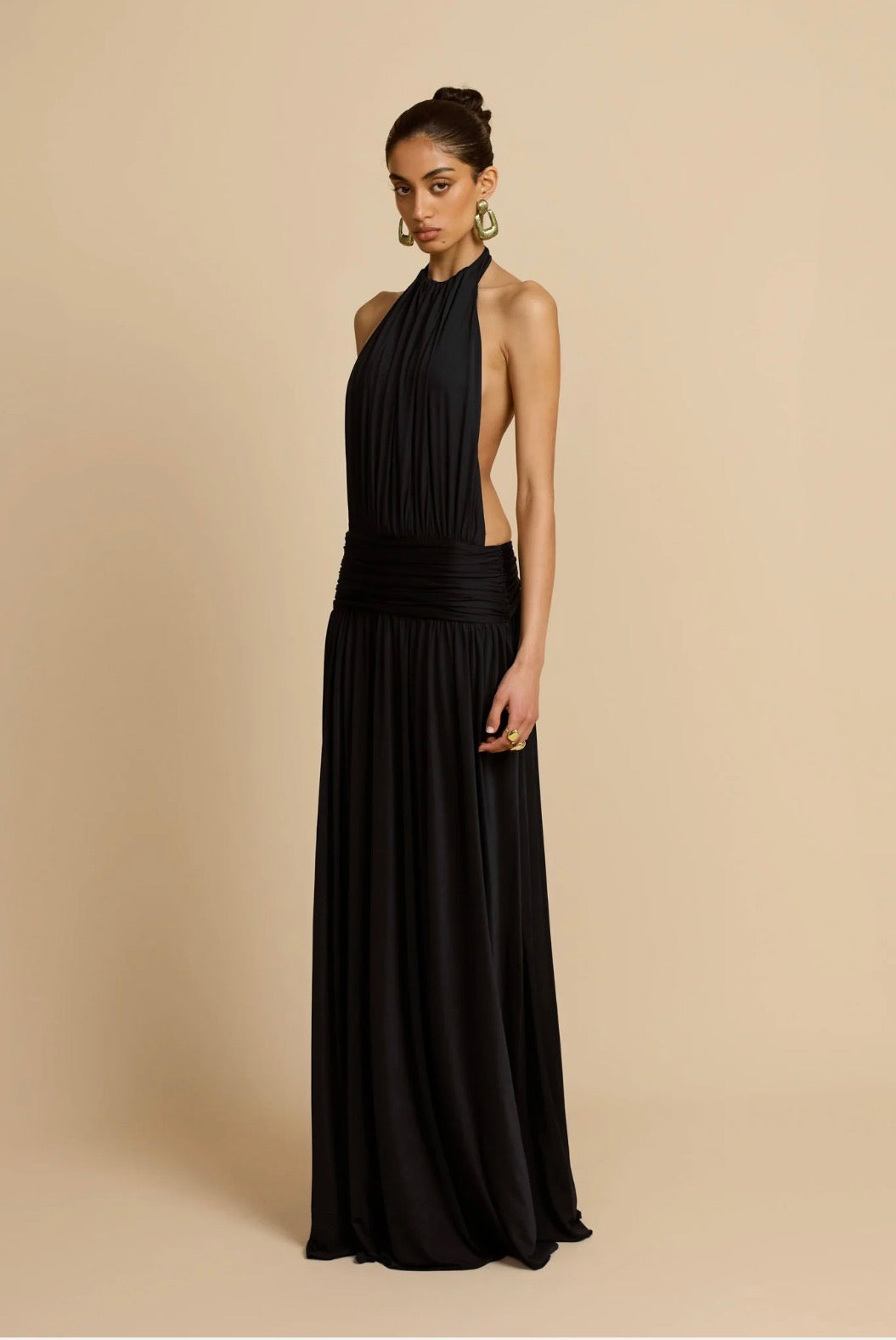 Black halter gown, side cutout, studio shot
