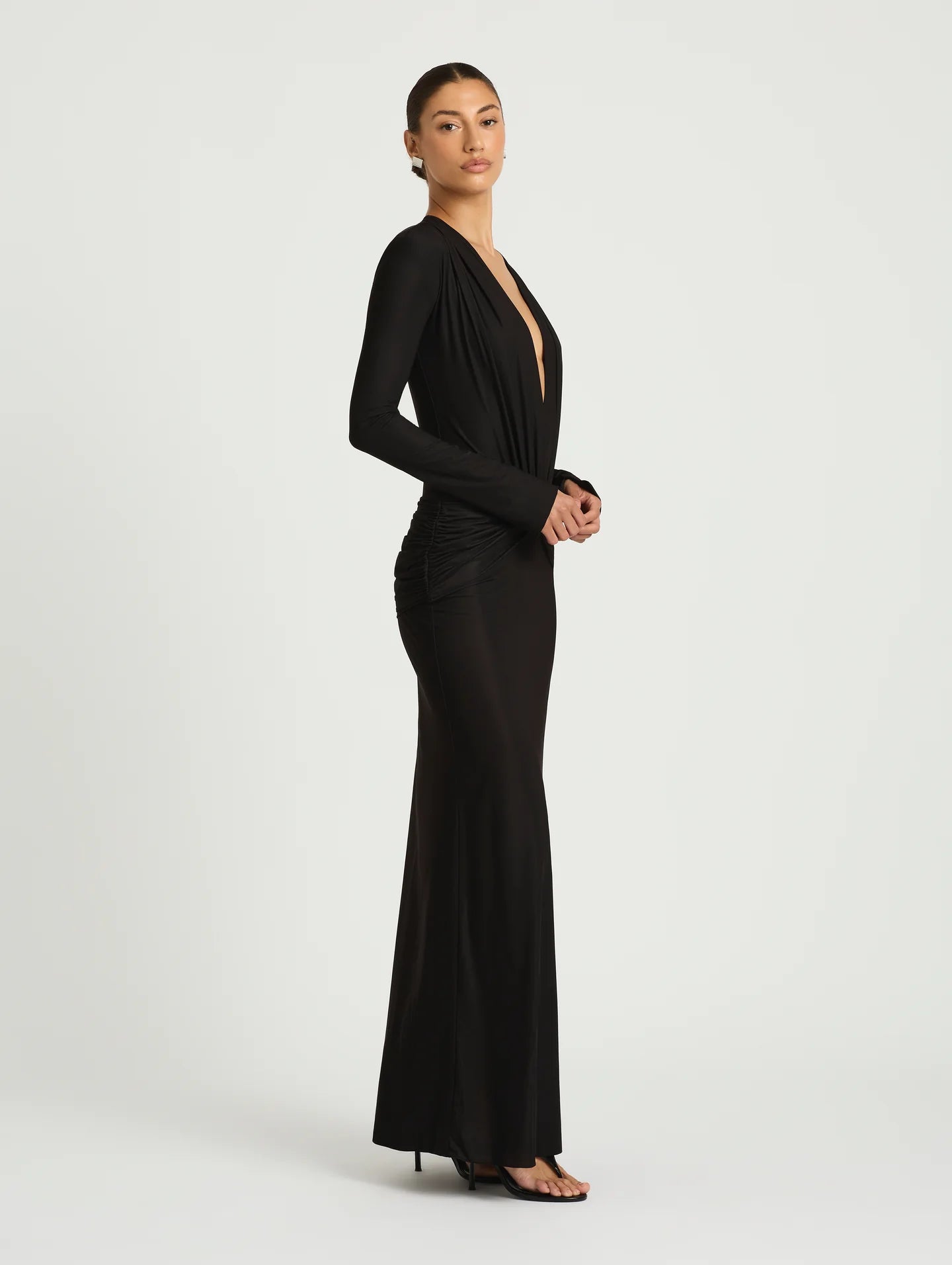 Woman wearing a black evening gown on a white background
