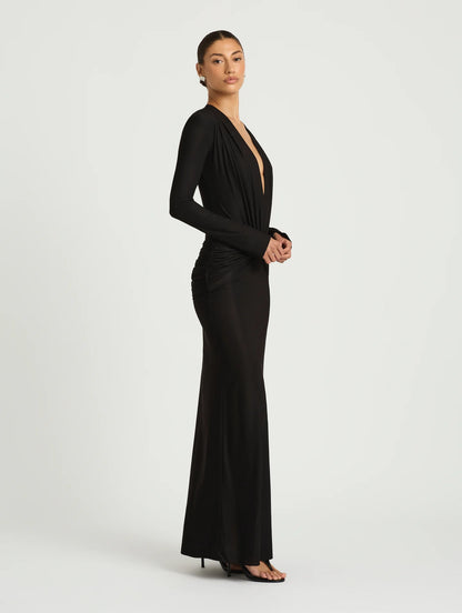 Woman wearing a black evening gown on a white background
