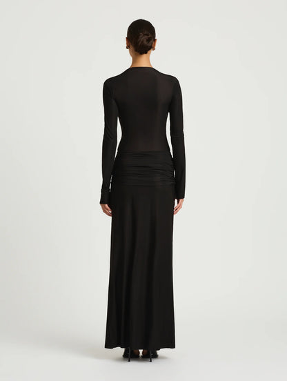 Black long-sleeve dress worn by a model on a white background