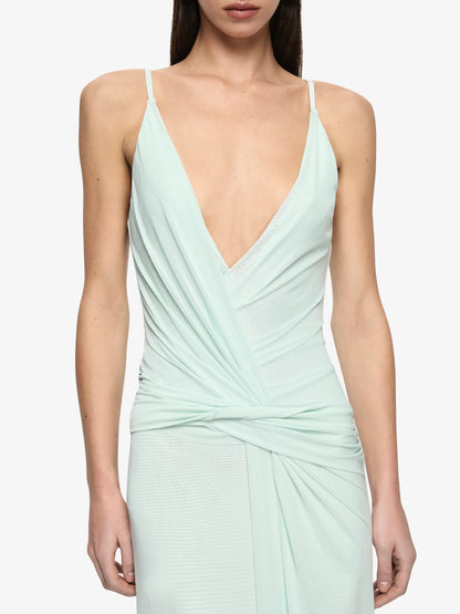 Mint green dress with a deep neckline on a white background