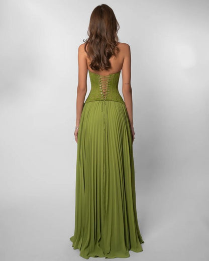 Green evening gown with open back on a white background